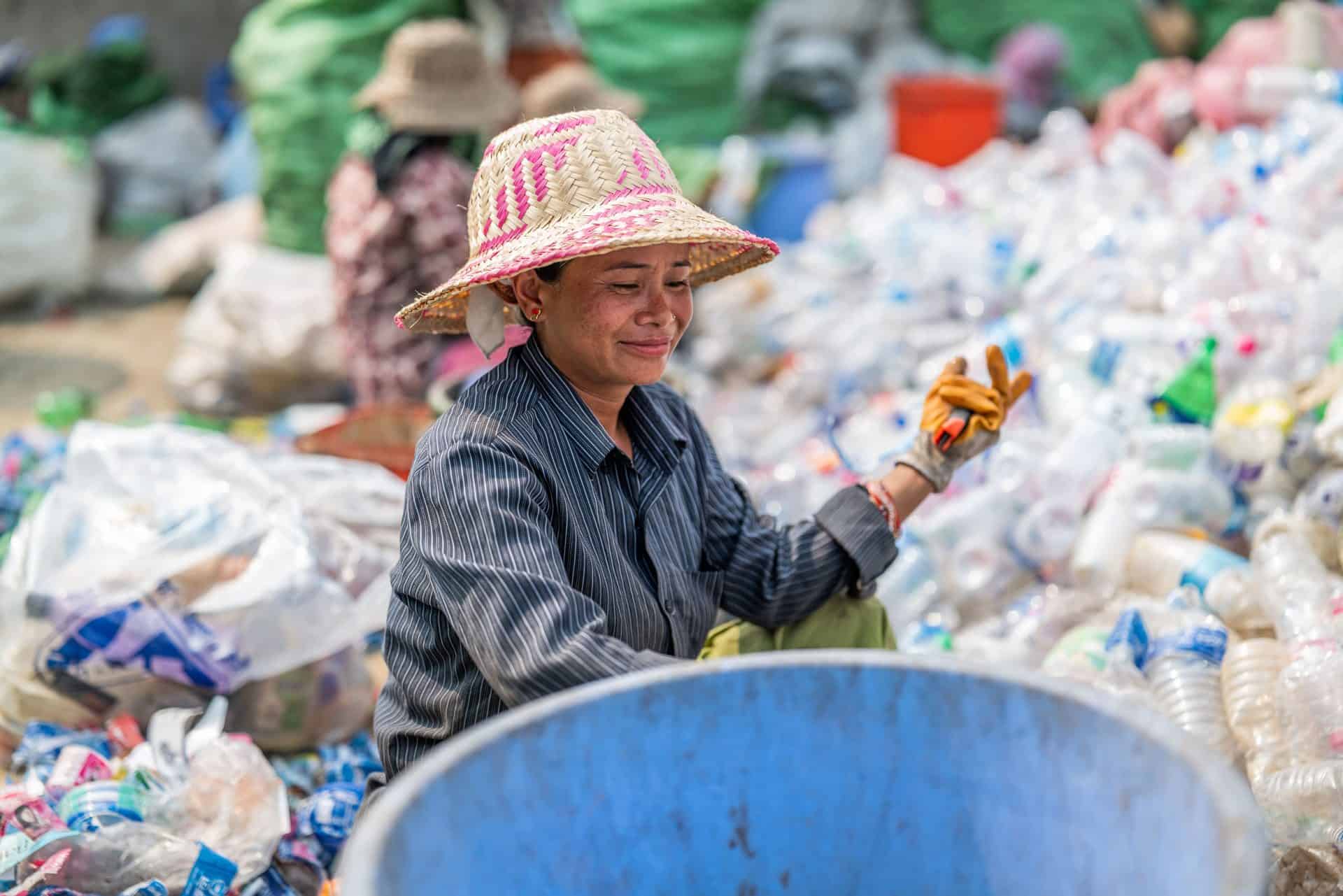 Woman sorts bottles at the plastics recycling facility operated by Himalayan Life