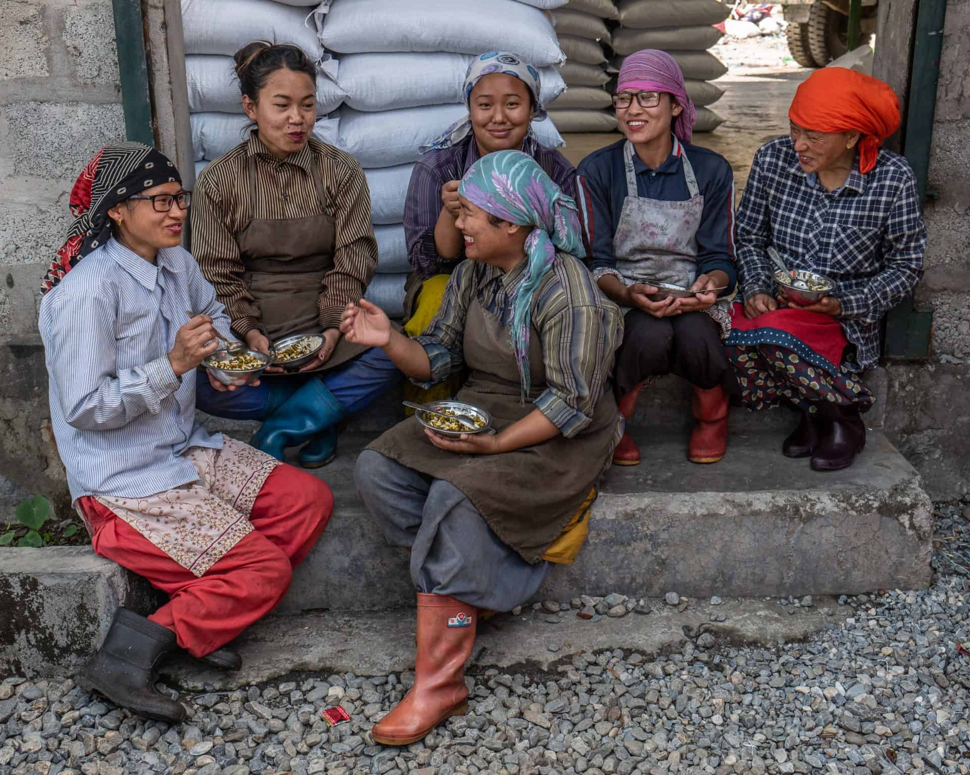 Women take a lunch break at the plastics recycling facility operated by Himalayan Life