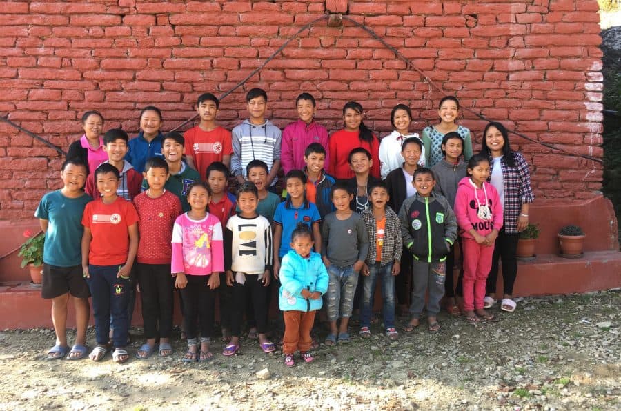 Children from the Himalayan Life Ulleri Children's Home get together outside the home for a photo