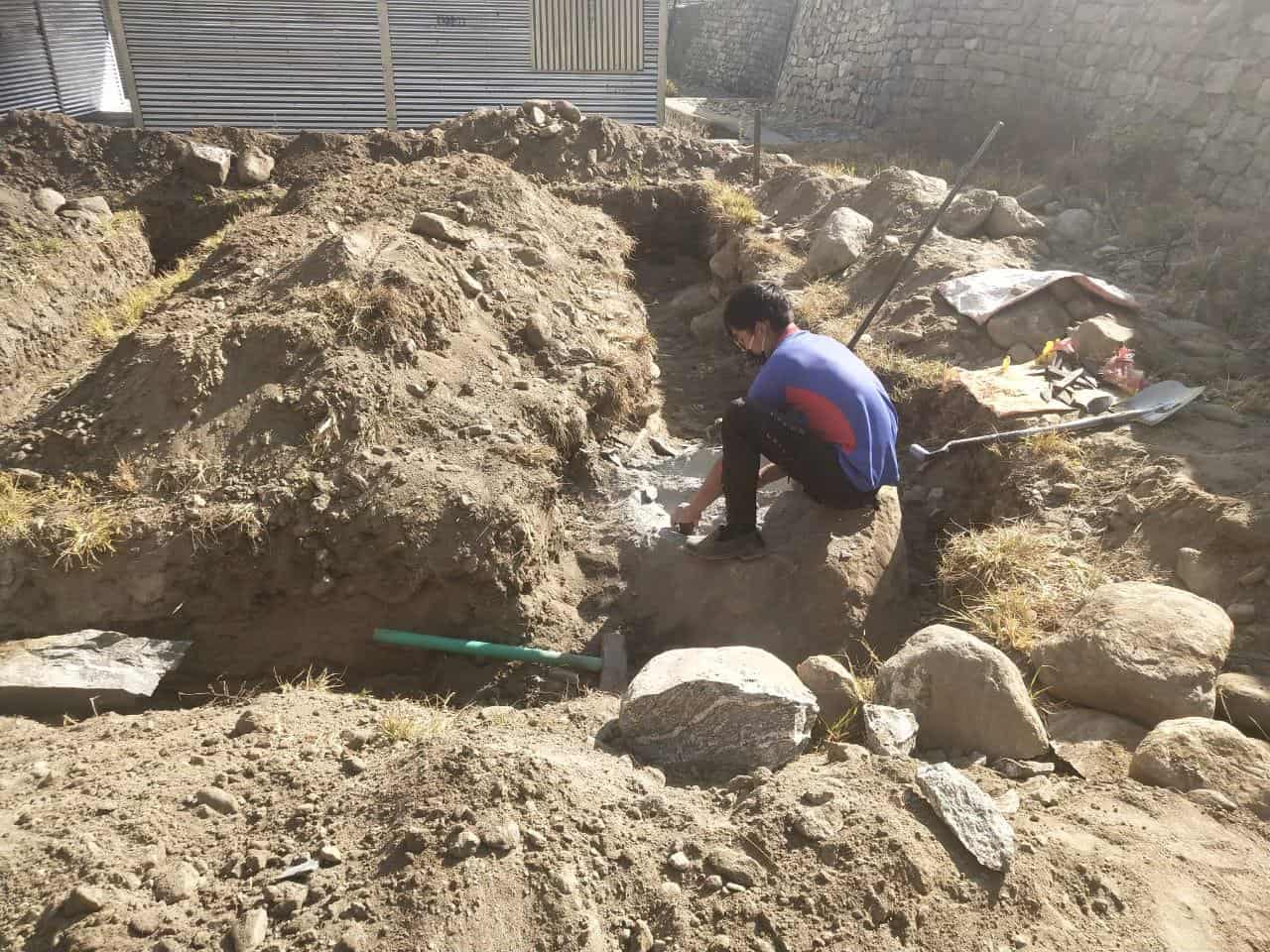 A worker pours footings for the new school to get it ready for the new school year to begin in Yangri, Nepal