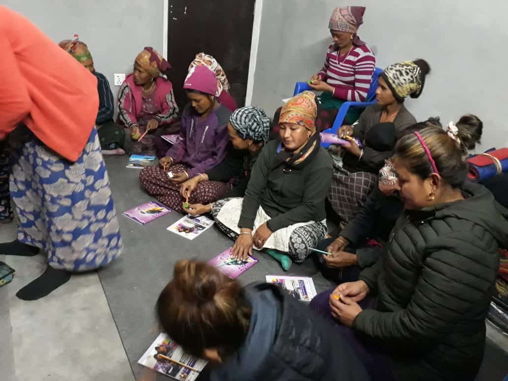 A group of mothers and middle aged women meet to learn to write and read as part of Himalayan Life's adult literacy program