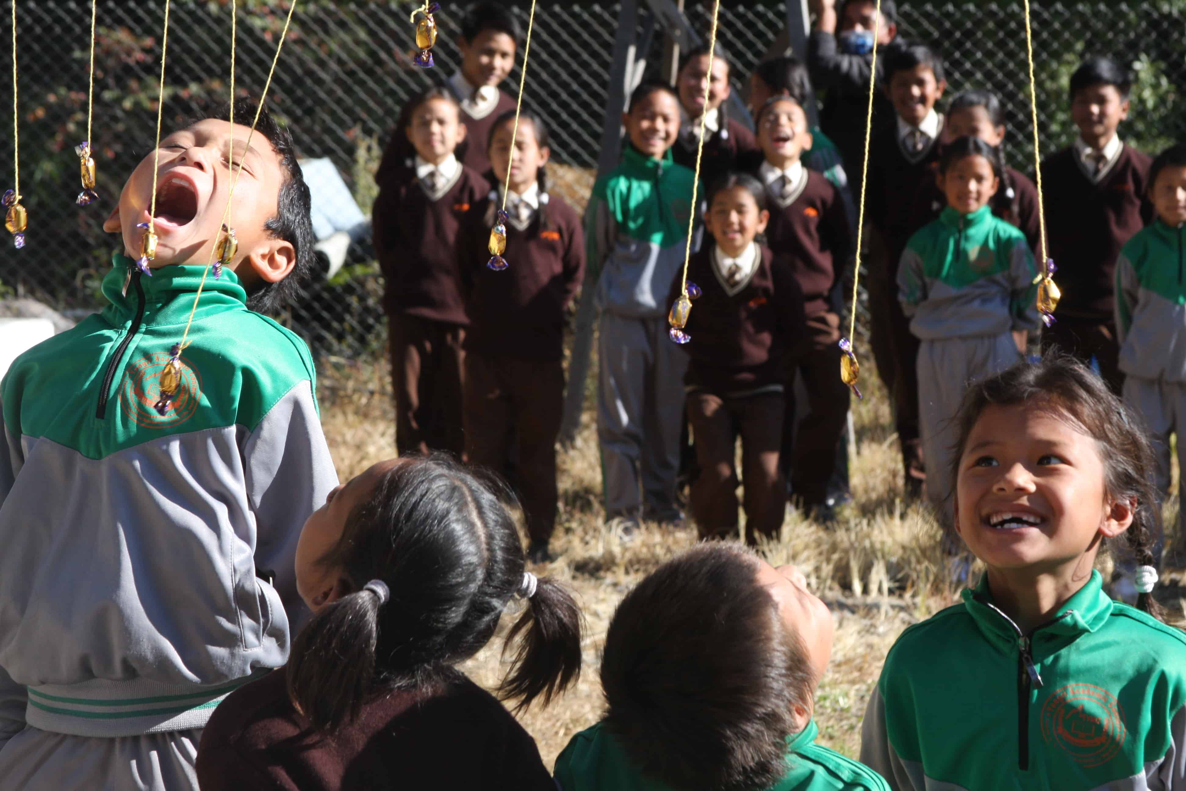 A group of students gather for fun games during the Project Week in Yangri, Nepal