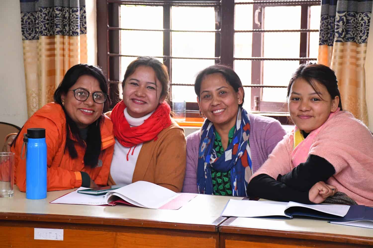 Four women staff members take a break from the Himalayan Life staff coference