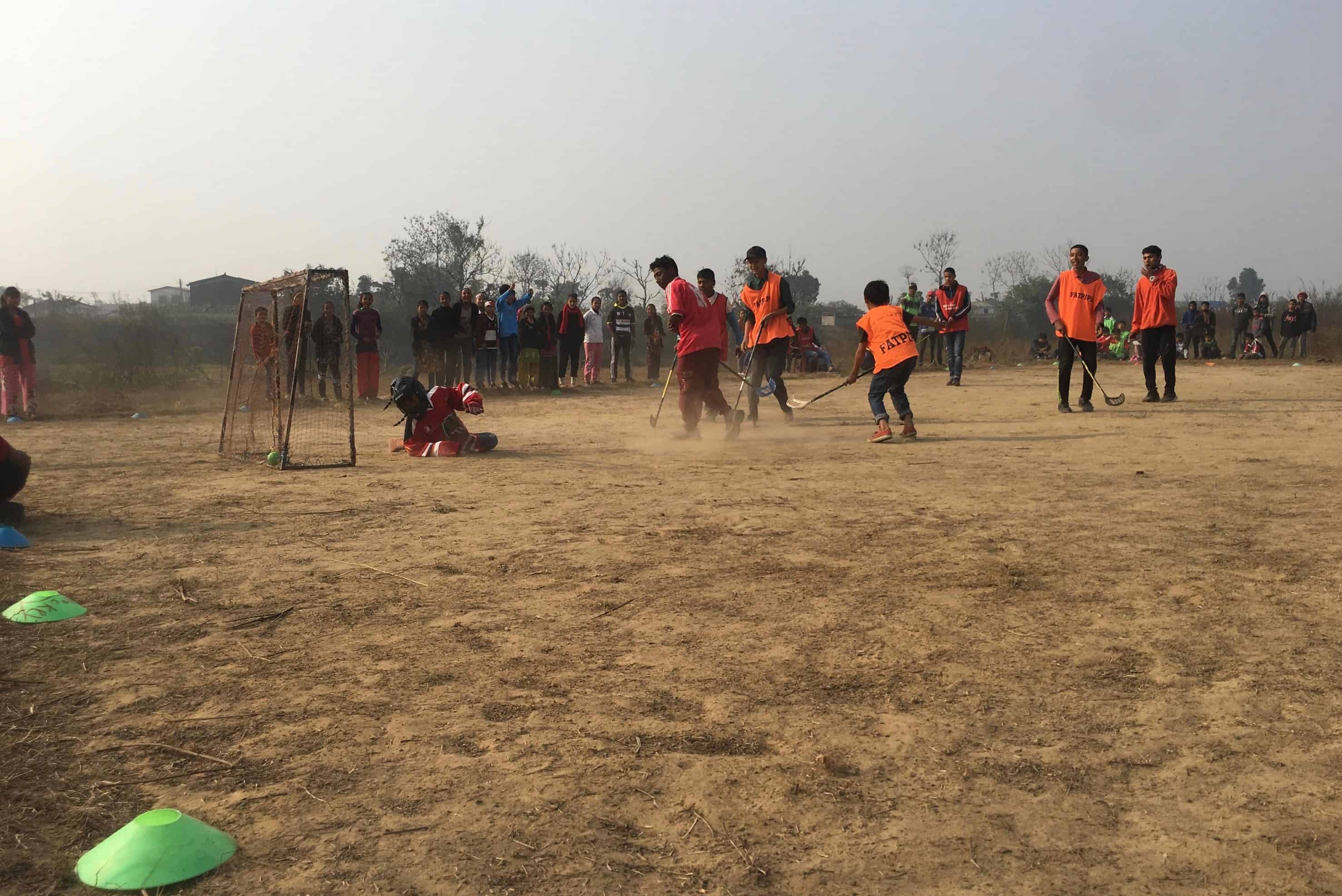 Students in Chitwan play field hockey as part of the day camps that Himalayan Life puts on