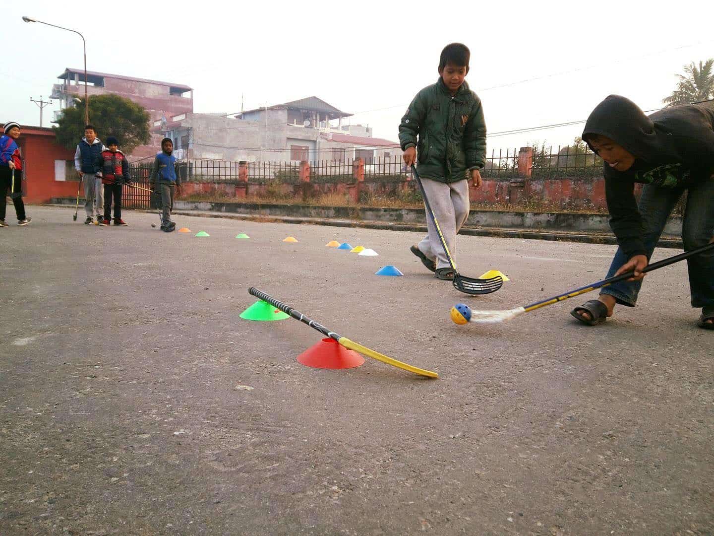 Street kids play street hockey in Chitwan, Nepal