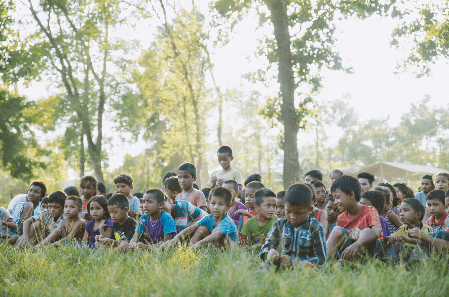 Reduced Inequalities, Children gather in a jungle field in Chitwan, Nepal to participate in community programs run by Himalayan Life