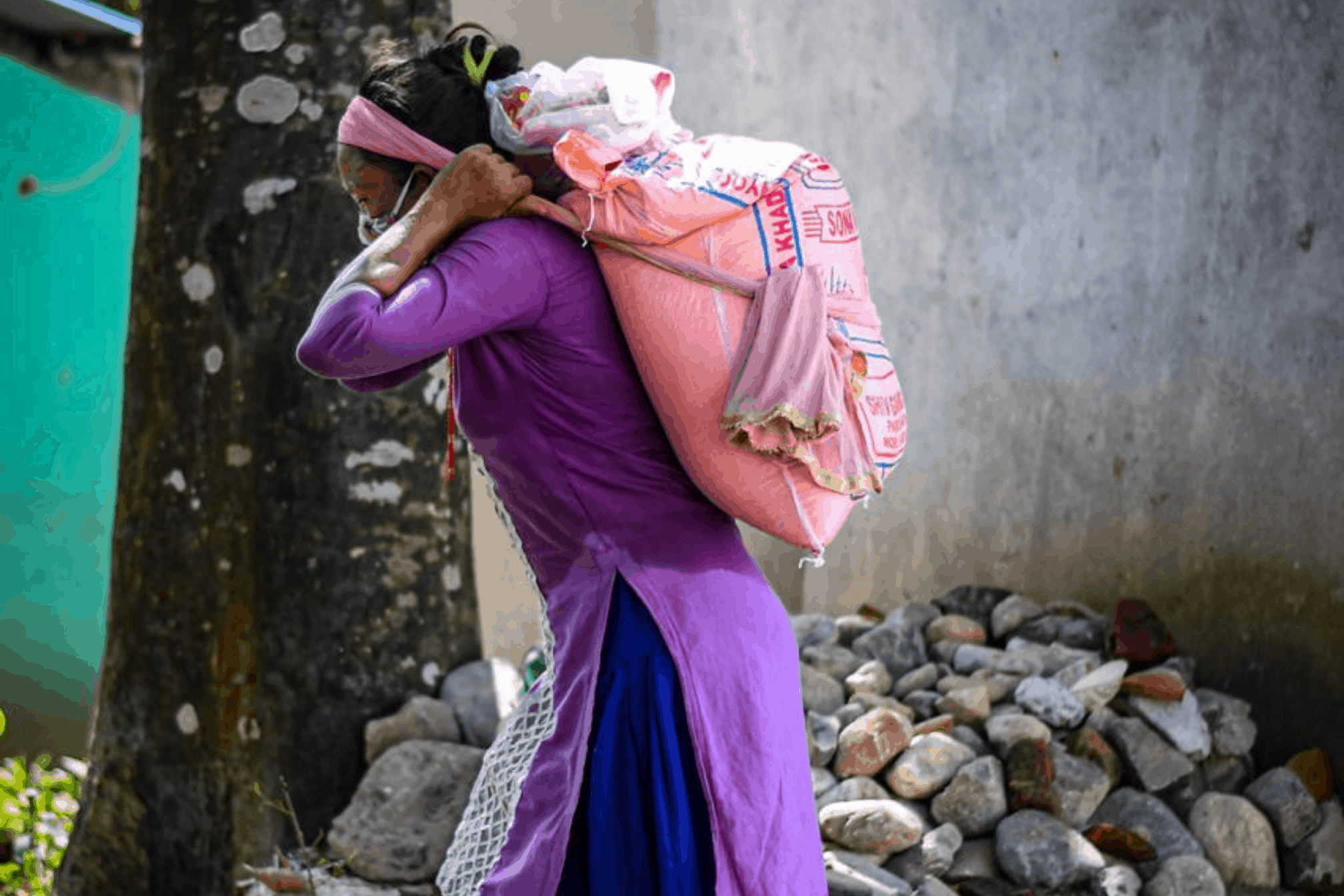 Woman carries supplies to her family given by Himalayan Life Chitwan for COVID-19 provisions