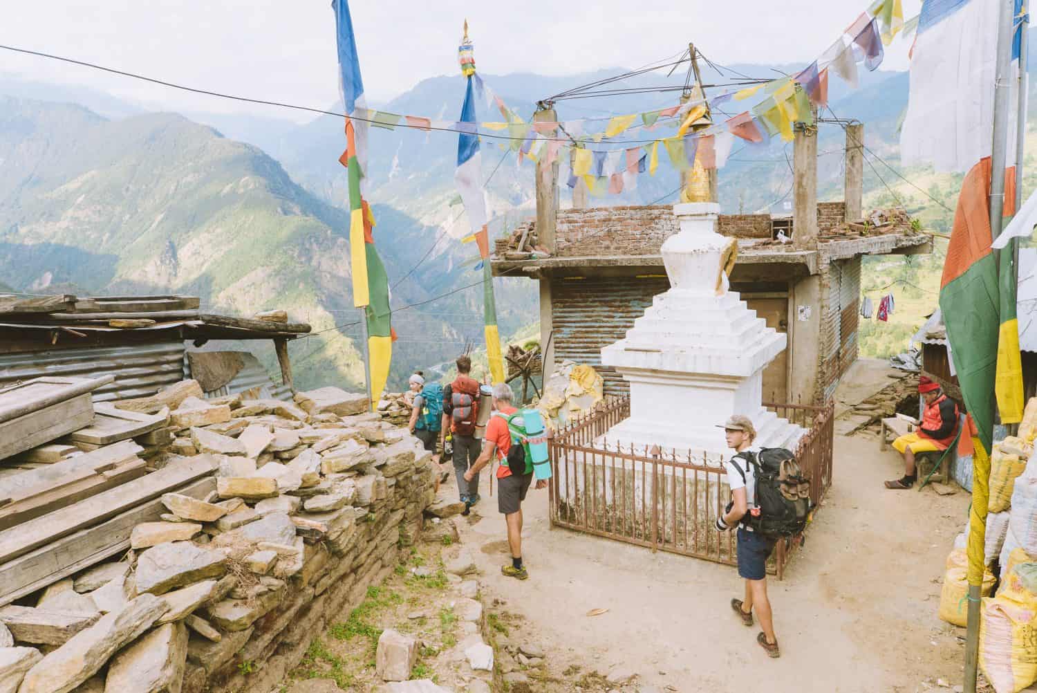 Himalayan Life Adventures trekking participants walk through a high Sherpa village in the Himalayas.