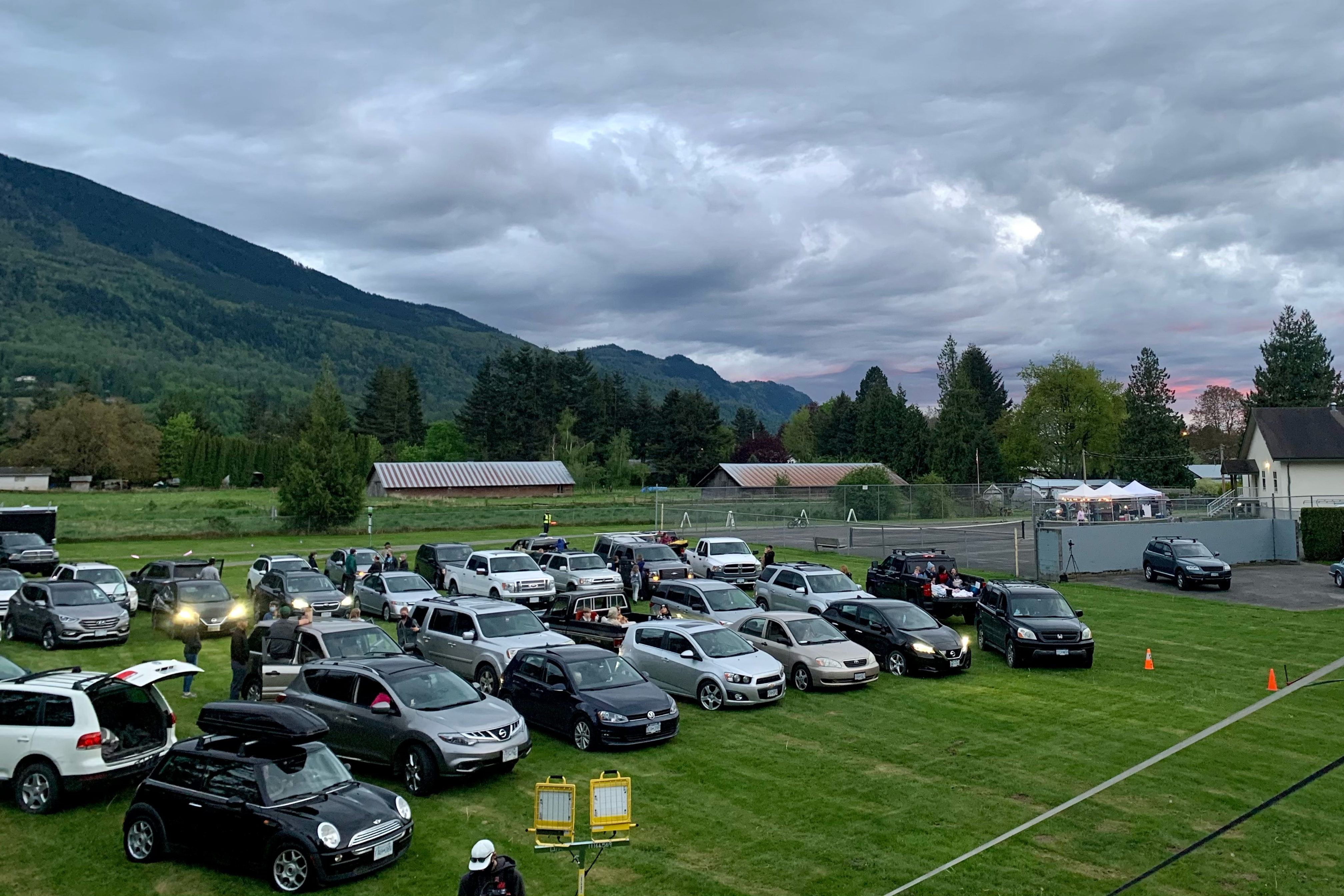 Cars are lined up in Yarrow, BC for Himalayan Life's showing of Himalaya, a film festival.